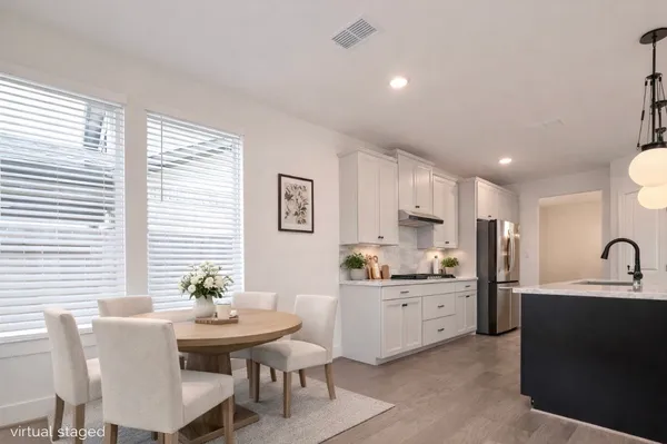 a kitchen with granite countertop a sink and white cabinets