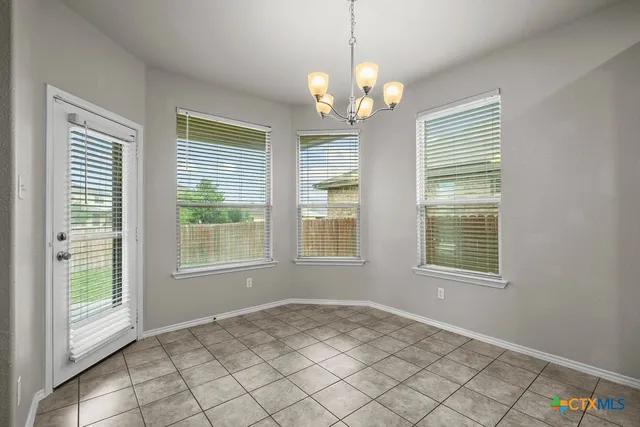 a view of an empty room with windows