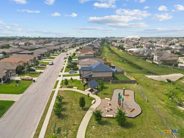 a view of a garden with a building in the background