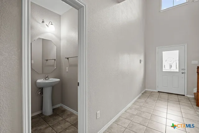 a bathroom with a sink a toilet and mirror