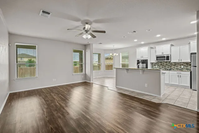 a view of kitchen with cabinets and wooden floor