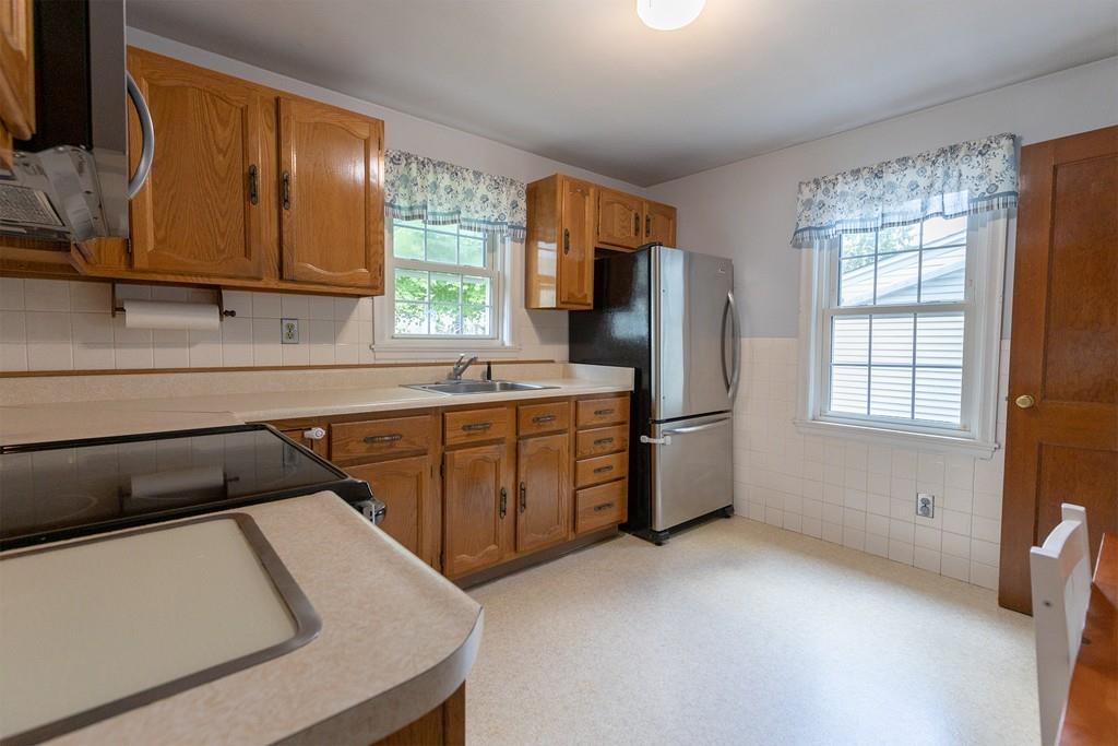 9 Laurel Road Braintree, MA 02184 - Photo 4 of 16 a kitchen with stainless steel appliances granite countertop a sink stove and refrigerator