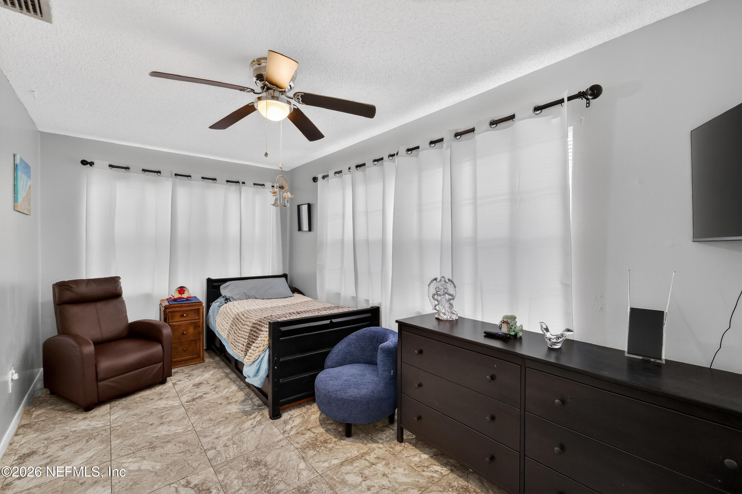 8654 Southwest 96th Street, Unit D Ocala, FL 34481 - Photo 16 of 25 a bed room with a bed and a chair