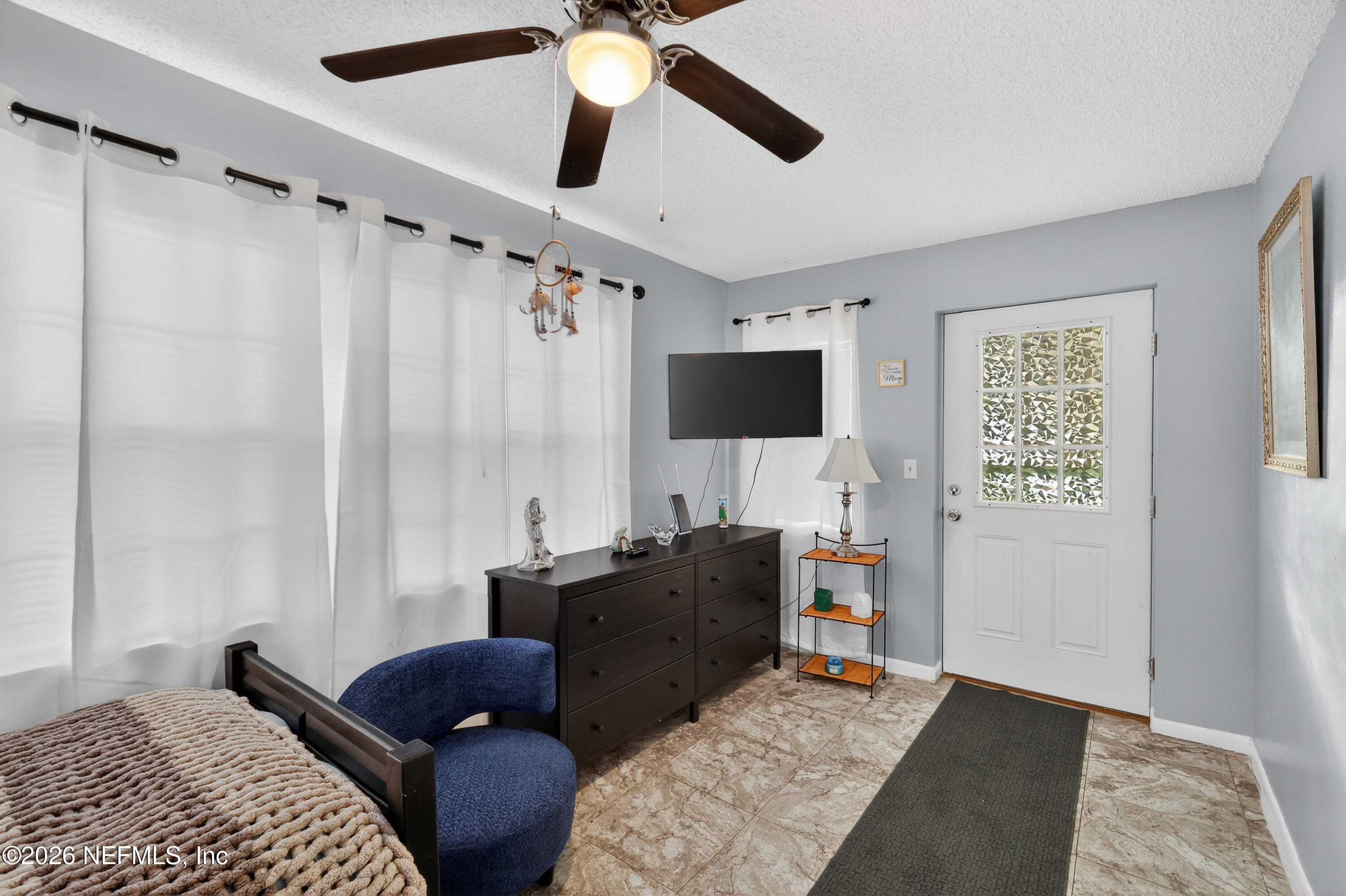 8654 Southwest 96th Street, Unit D Ocala, FL 34481 - Photo 17 of 25 a living room with furniture and a flat screen tv