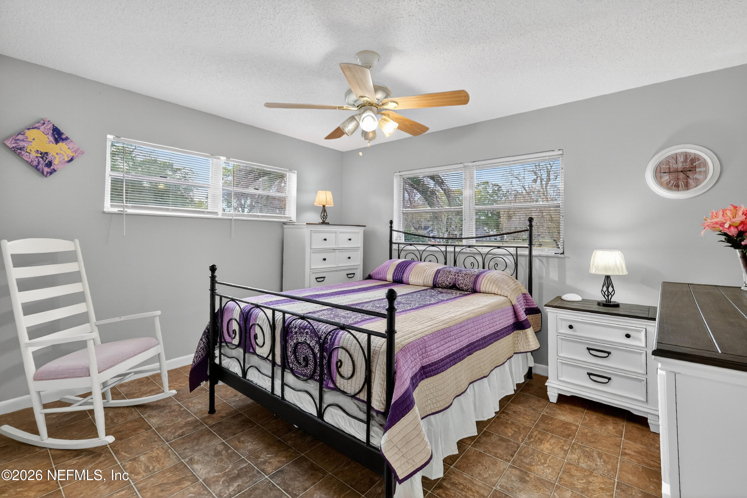 8654 Southwest 96th Street, Unit D Ocala, FL 34481 - Photo 20 of 25 a bedroom with a bed and a chandelier