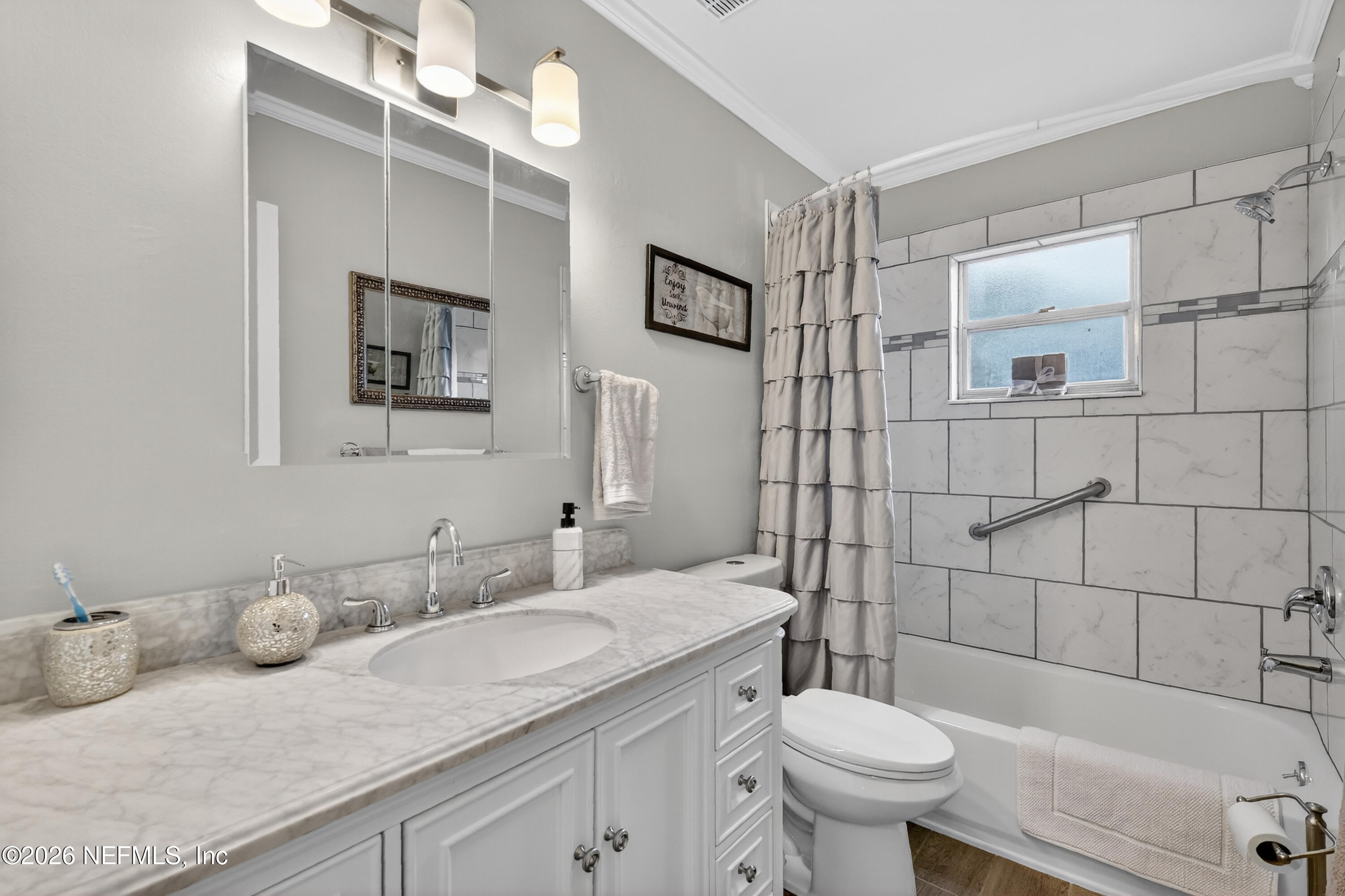 8654 Southwest 96th Street, Unit D Ocala, FL 34481 - Photo 21 of 25 a bathroom with a granite countertop sink mirror vanity and toilet