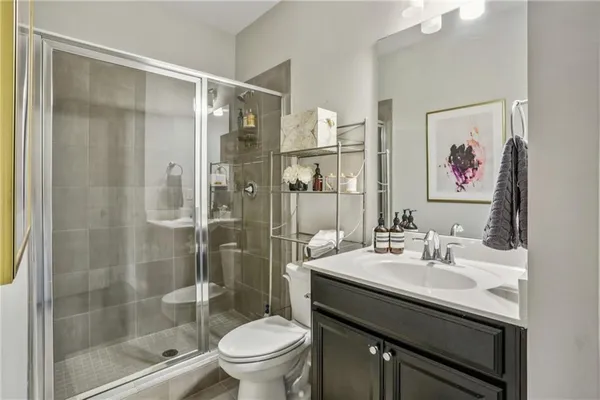 a bathroom with a sink shower and a toilet