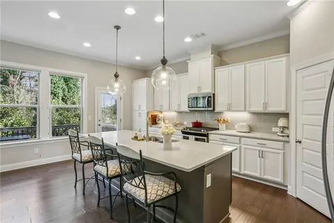 a kitchen with a sink stove and cabinets