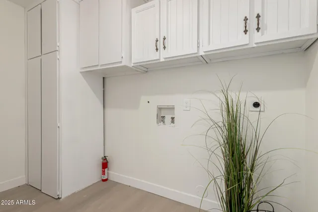 a view of small space with white cabinets
