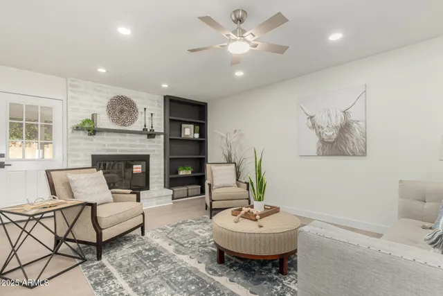 a living room with furniture and a fireplace
