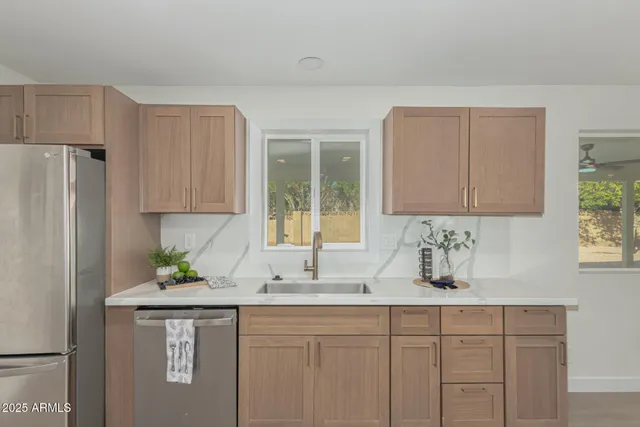 a kitchen with stainless steel appliances white cabinets and a sink