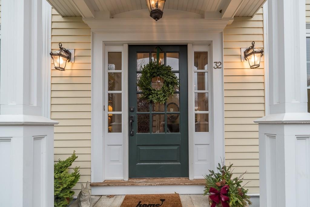 a front view of a house with a potted plant