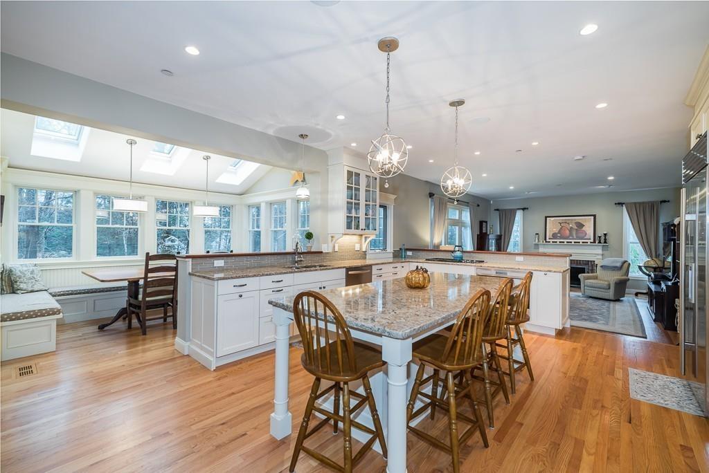 32 Parsons Hill Road Wenham, MA 01984 - Photo 6 of 29 a dining area with a table chairs and a kitchen view
