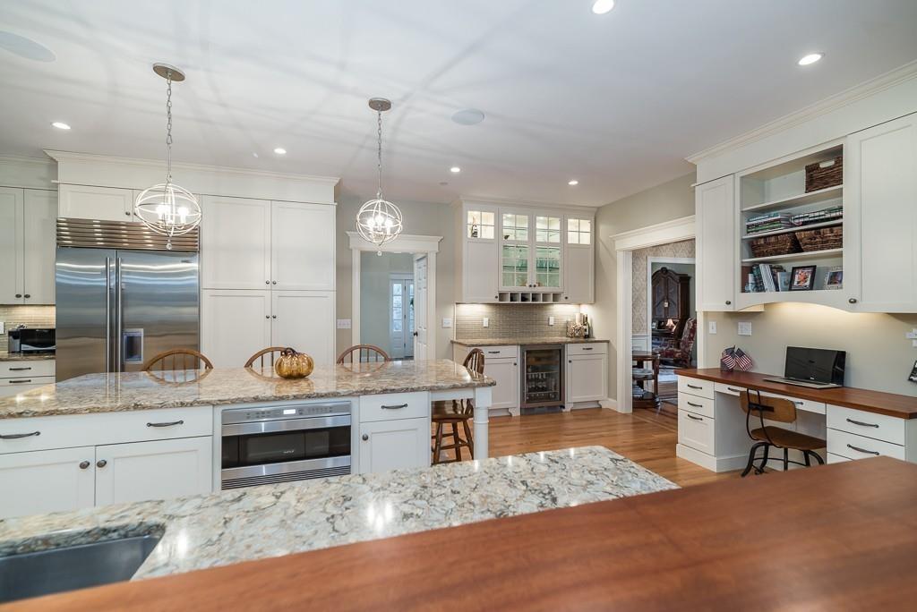 32 Parsons Hill Road Wenham, MA 01984 - Photo 8 of 29 a large kitchen with stainless steel appliances kitchen island granite countertop a sink counter space and cabinets