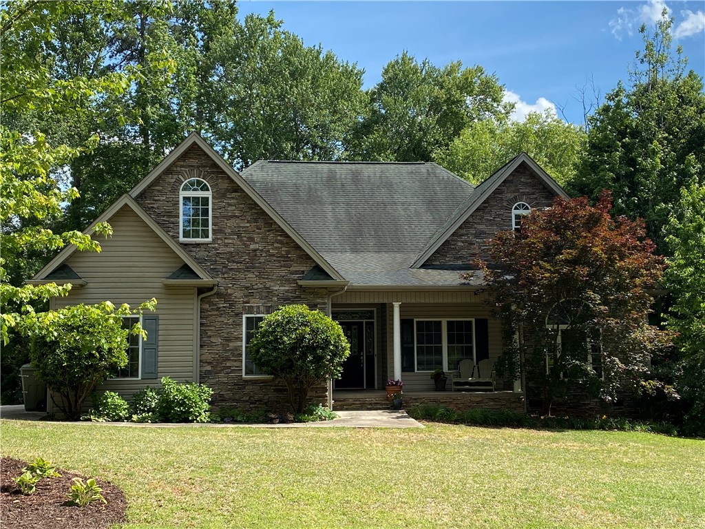 Charming curb appeal with broad lawn and quaint sh