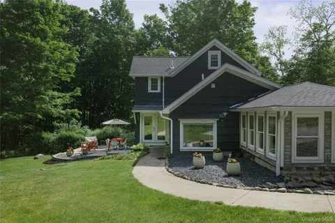 a front view of a house with a yard table and chairs