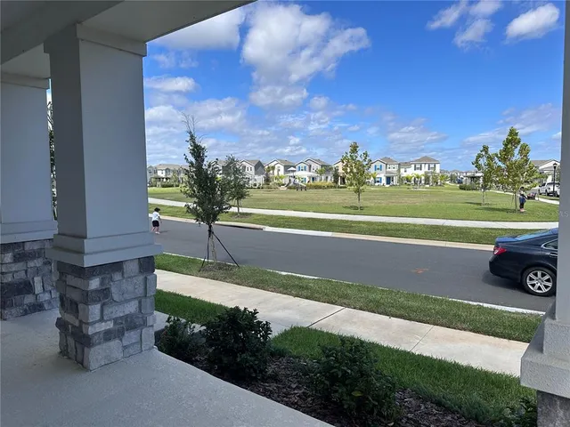 a view of a house with a yard and a garden
