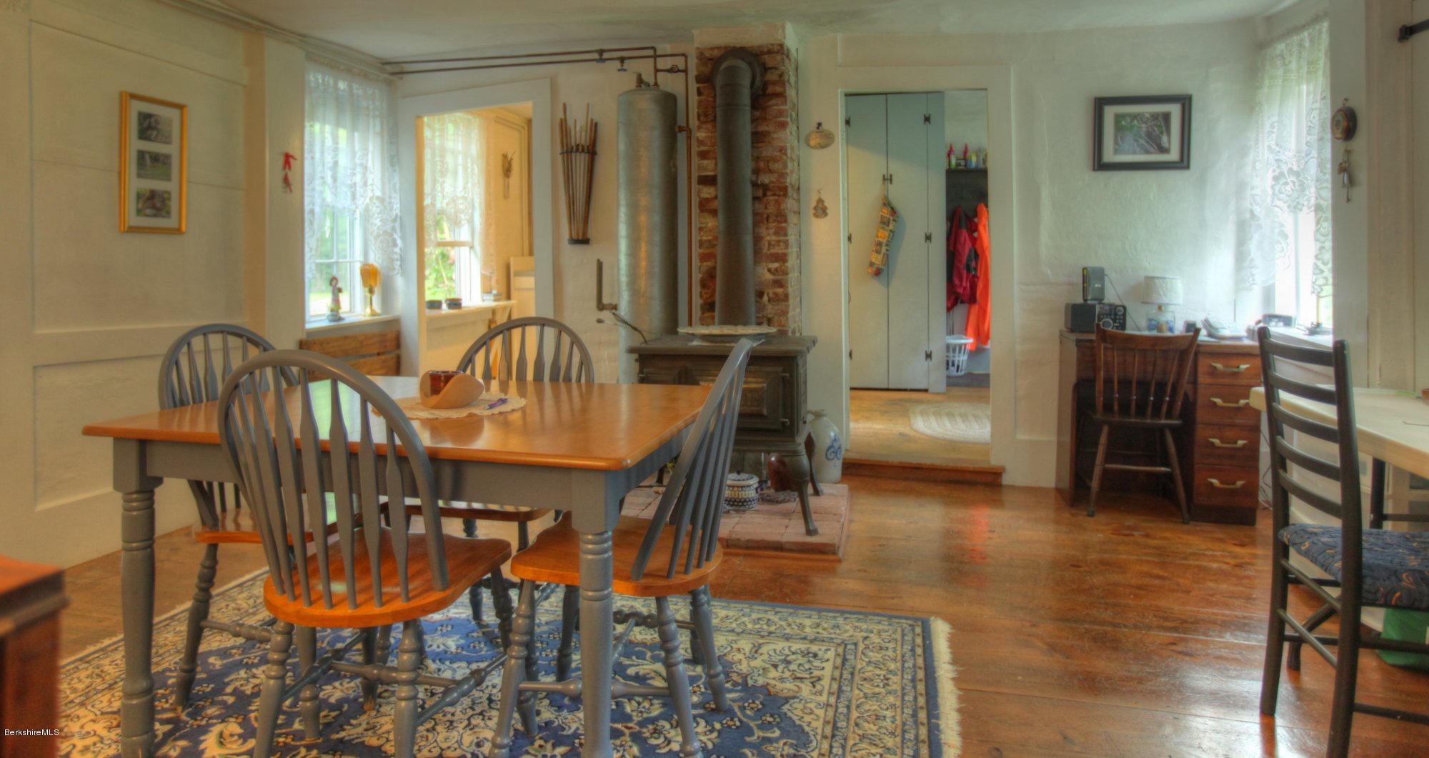 58 Mt Hunger Road Monterey, MA 01245 - Photo 13 of 32 a dining room with furniture and a chandelier