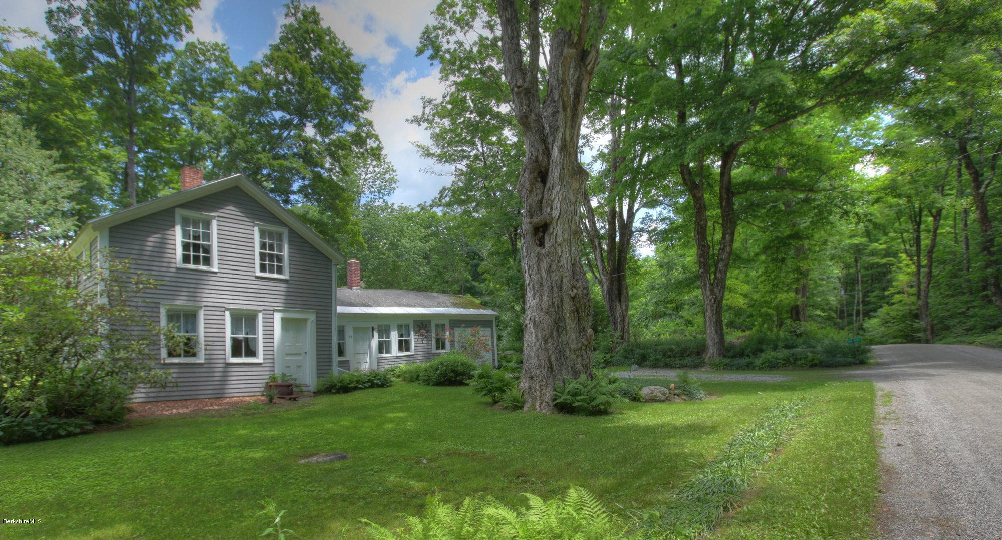 58 Mt Hunger Road Monterey, MA 01245 - Photo 3 of 32 a front view of a house with a yard and trees