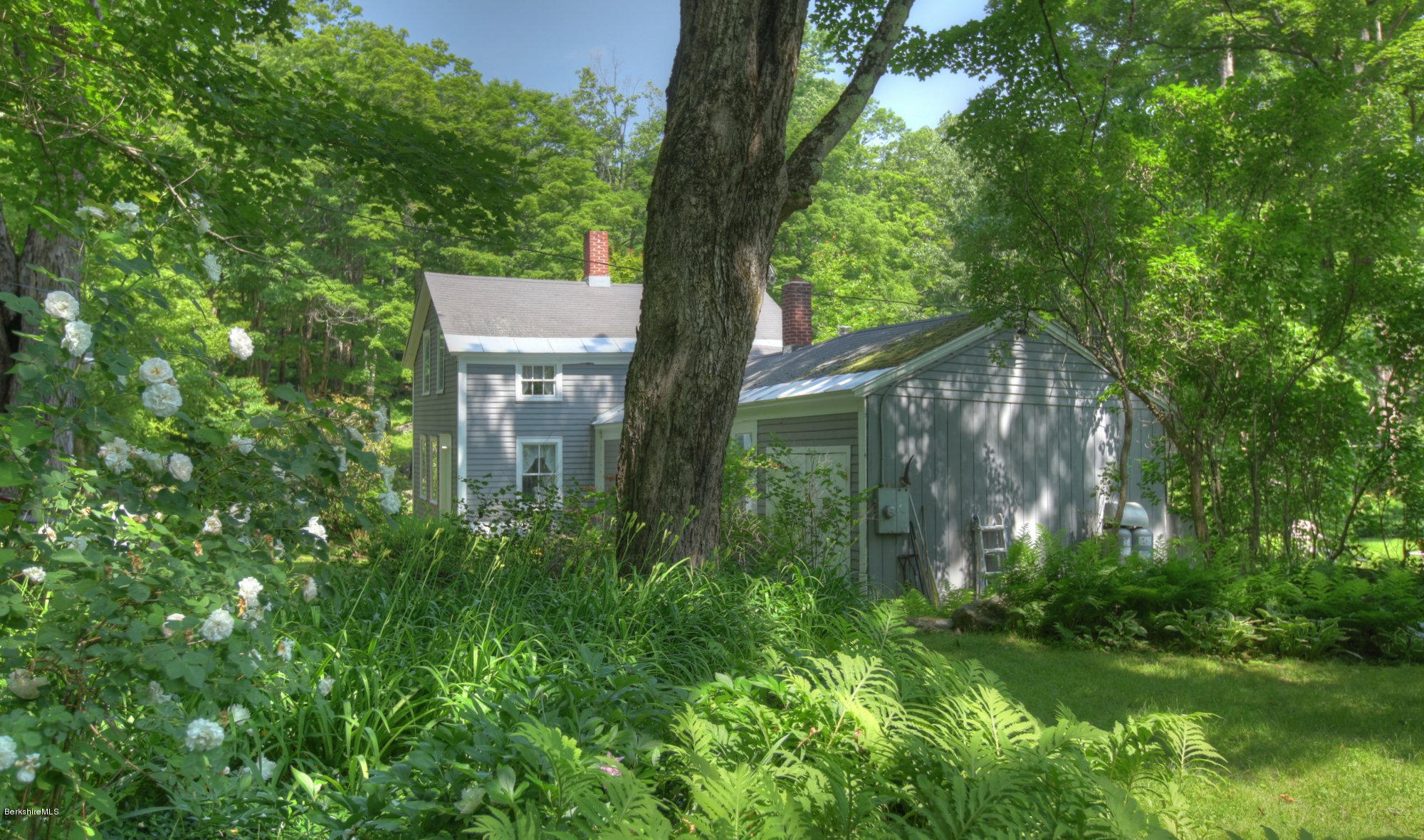 58 Mt Hunger Road Monterey, MA 01245 - Photo 23 of 32 a backyard of a house with lots of green space and fountain