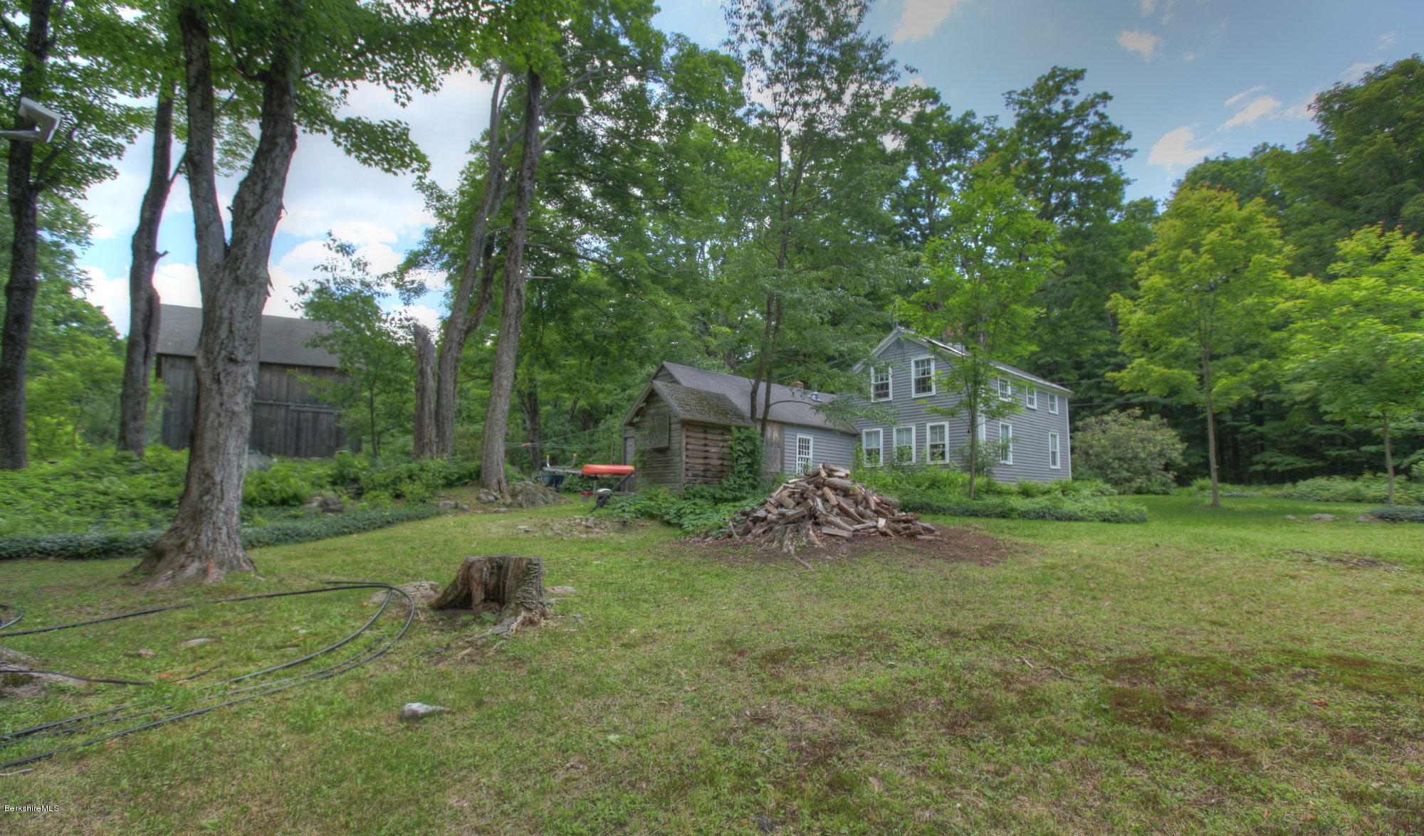 58 Mt Hunger Road Monterey, MA 01245 - Photo 25 of 32 a backyard of a house with table and chairs