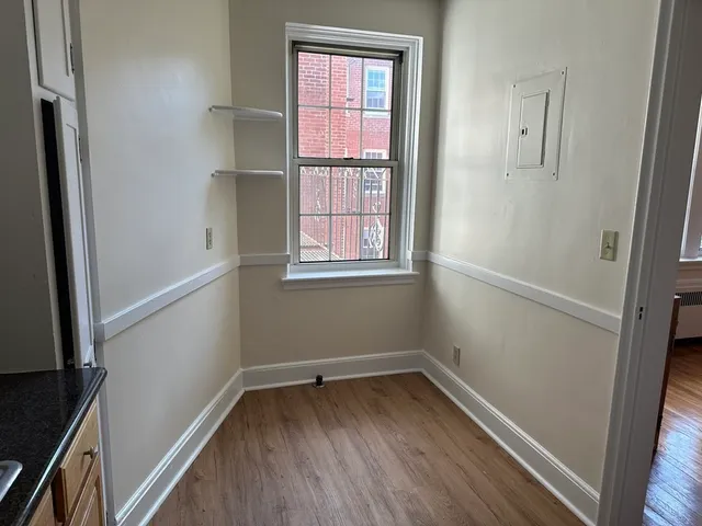 a view of a room with wooden floor and windows