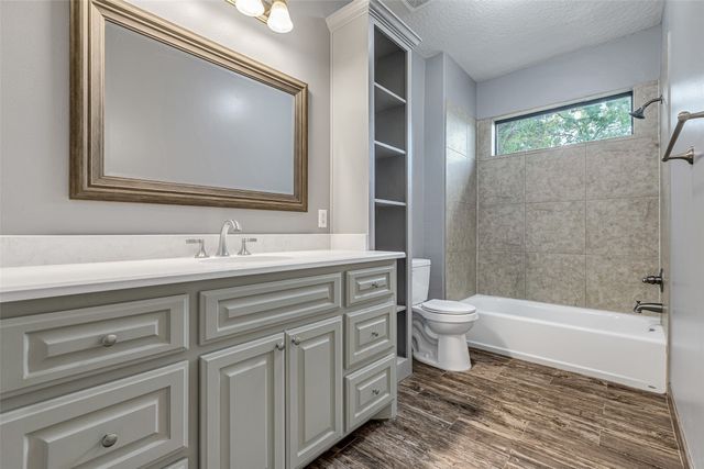 a bathroom with a double vanity sink toilet and shower