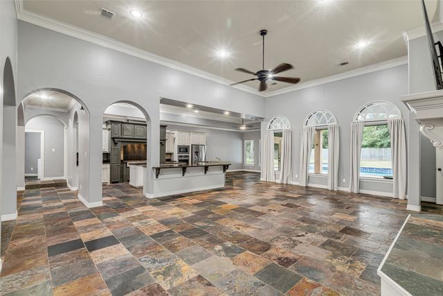 a view of a hall with dining table and chairs