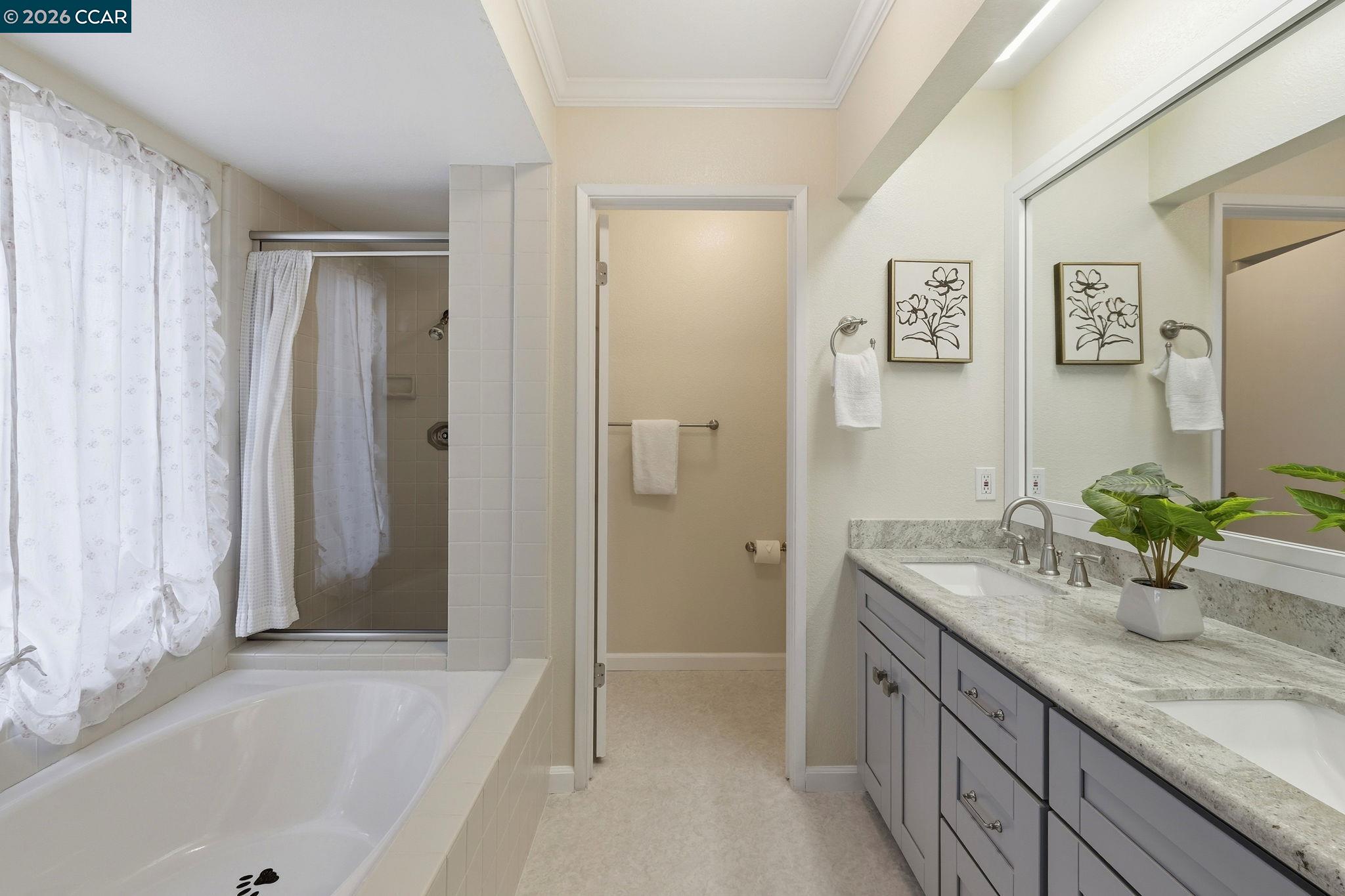 1707 Geary Road Walnut Creek, CA 94597 - Photo 29 of 43 a bathroom with a granite countertop sink a mirror and a bathtub