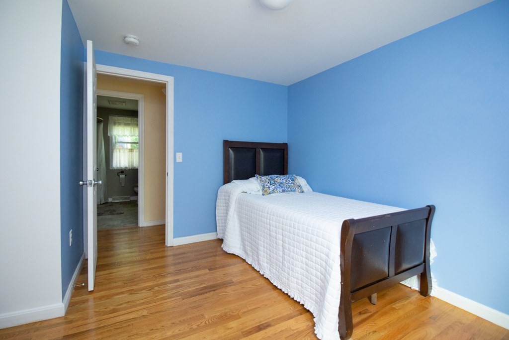 139 Fox Hill Road Springfield, MA 01118 - Photo 18 of 36 a bedroom with a bed and wooden floor