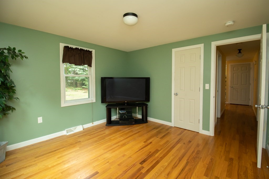 139 Fox Hill Road Springfield, MA 01118 - Photo 21 of 36 a bedroom with a bed and a flat screen tv