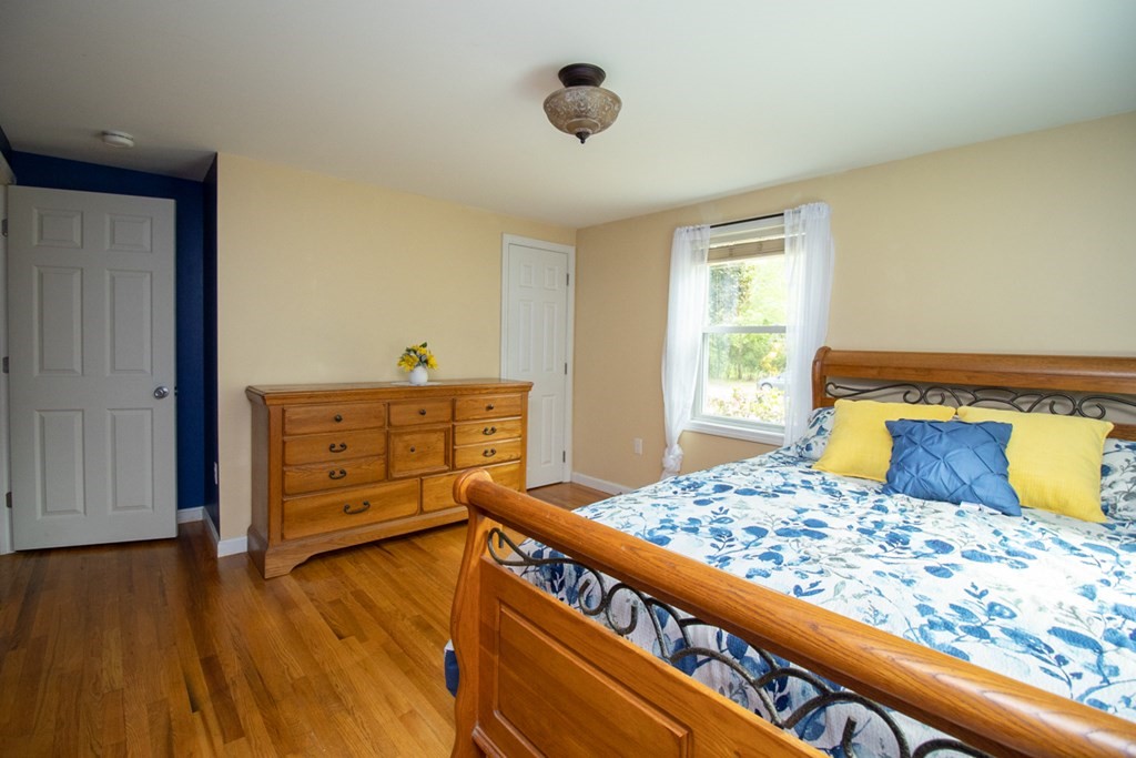 139 Fox Hill Road Springfield, MA 01118 - Photo 26 of 36 a bedroom with a bed and wooden floor