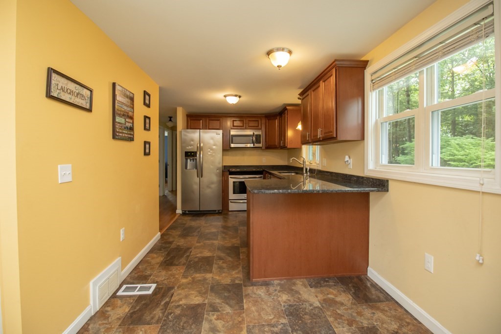 139 Fox Hill Road Springfield, MA 01118 - Photo 7 of 36 a kitchen with stainless steel appliances granite countertop a refrigerator and a stove