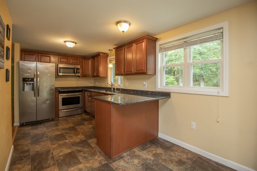 139 Fox Hill Road Springfield, MA 01118 - Photo 8 of 36 a large kitchen with stainless steel appliances granite countertop a stove a sink and a refrigerator