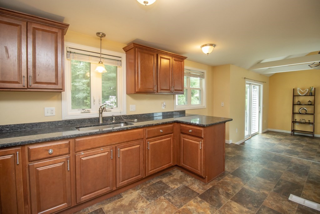 139 Fox Hill Road Springfield, MA 01118 - Photo 10 of 36 a kitchen with granite countertop wooden cabinets stainless steel appliances a sink and a window
