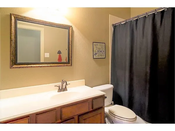 a bathroom with a sink a toilet and mirror