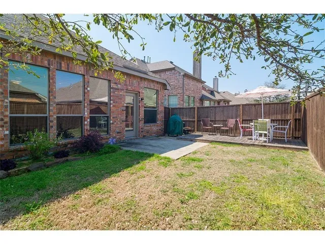 a swimming pool with outdoor seating and yard