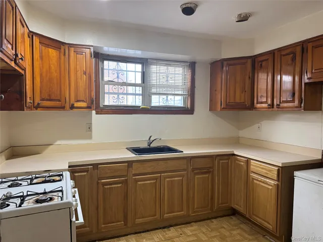 a kitchen with stainless steel appliances granite countertop a sink stove and cabinets