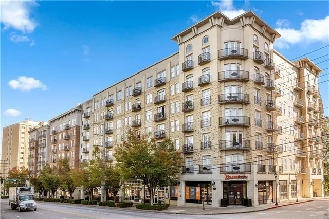 a view of a tall building next to a road