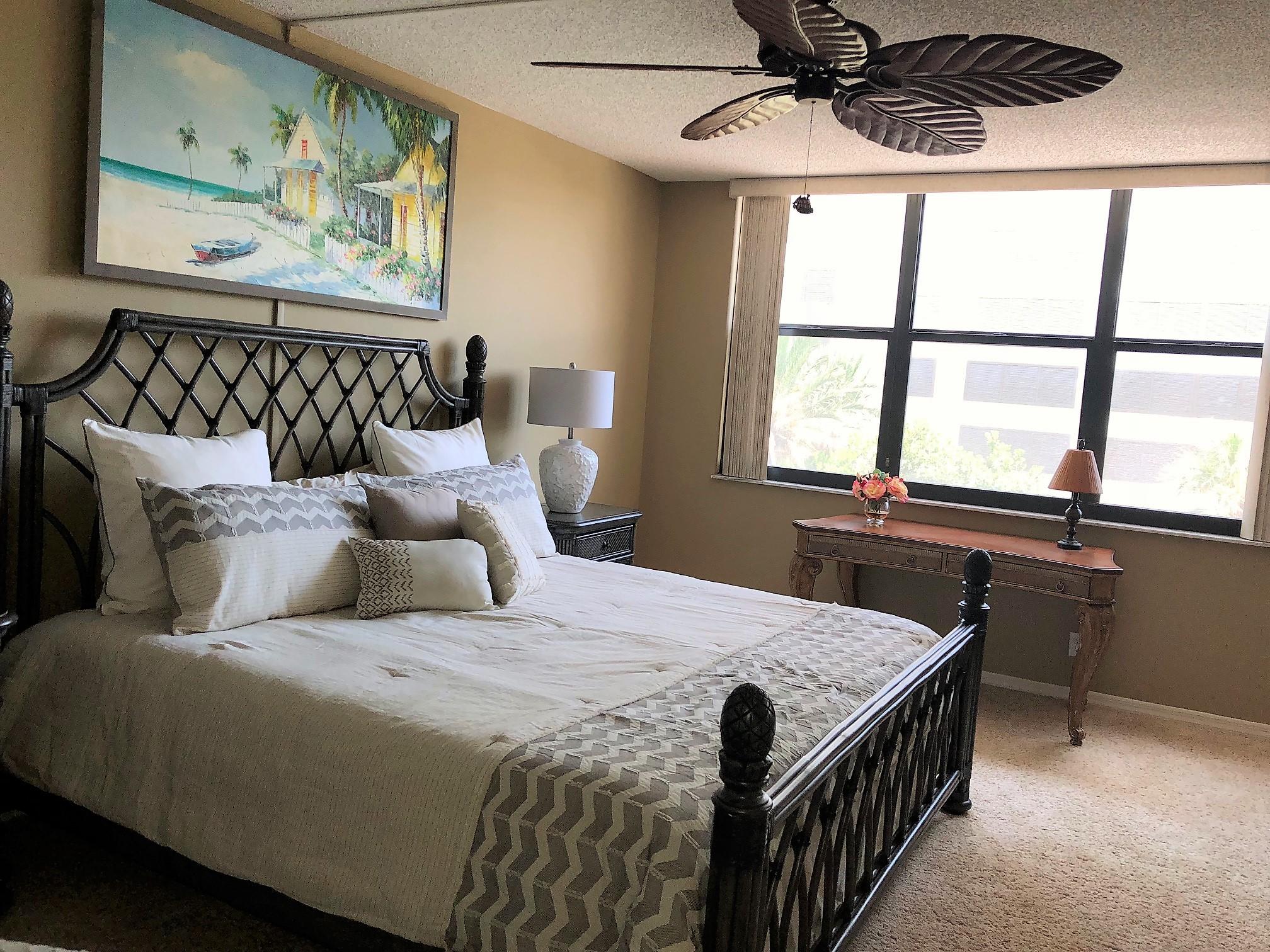 3400 North Ocean Drive, Unit 306 Riviera Beach, FL 33404 - Photo 13 of 52 a bed sitting in a bedroom next to a window