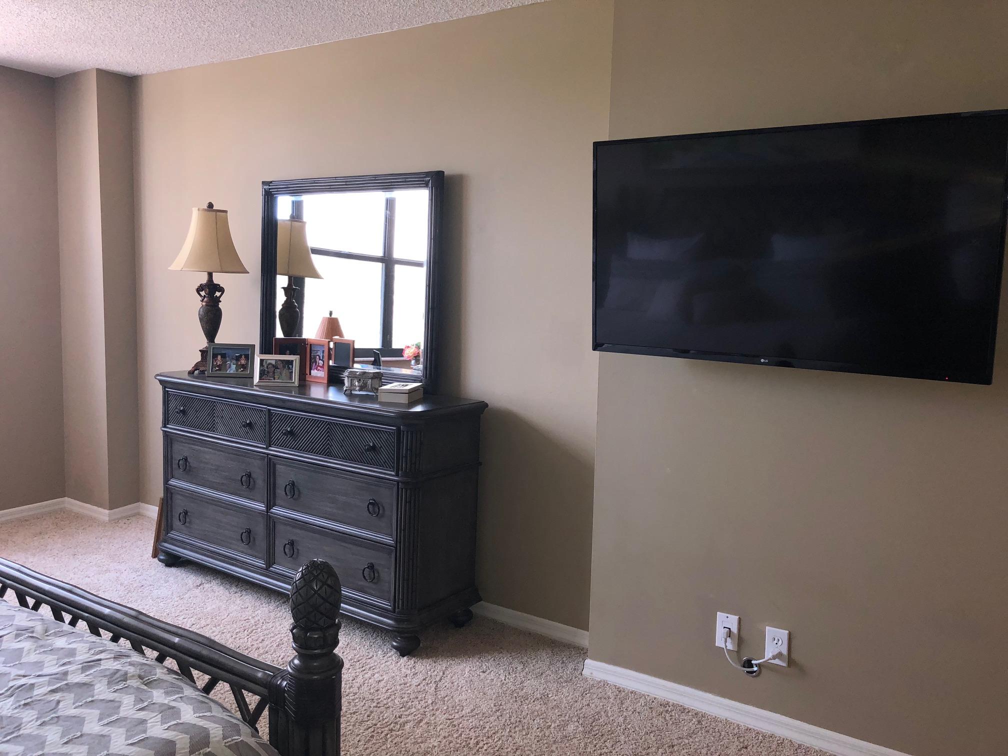 3400 North Ocean Drive, Unit 306 Riviera Beach, FL 33404 - Photo 14 of 52 a room with a chair and a flat screen tv