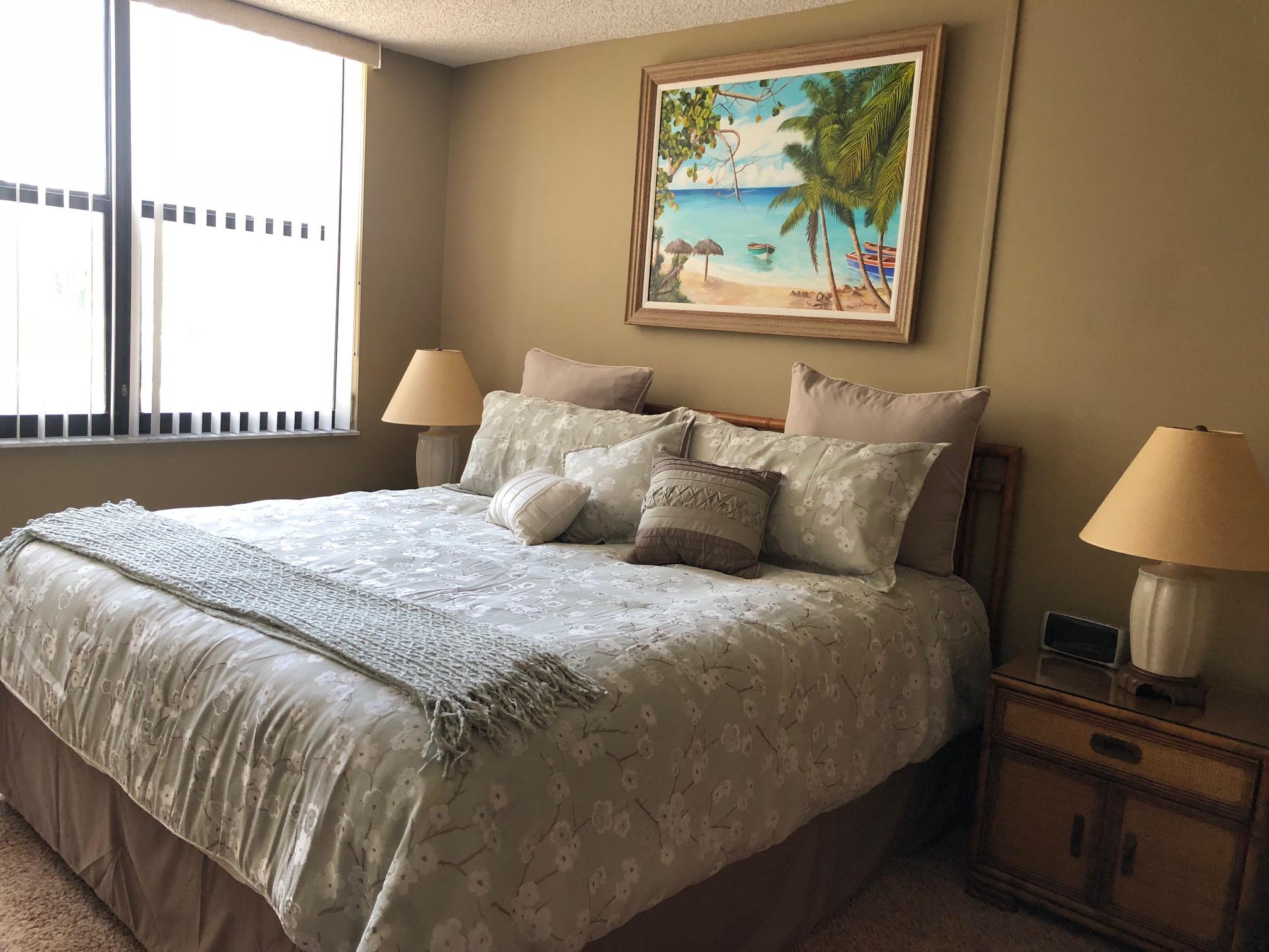 3400 North Ocean Drive, Unit 306 Riviera Beach, FL 33404 - Photo 21 of 52 a bedroom with a bed and a painting on the wall