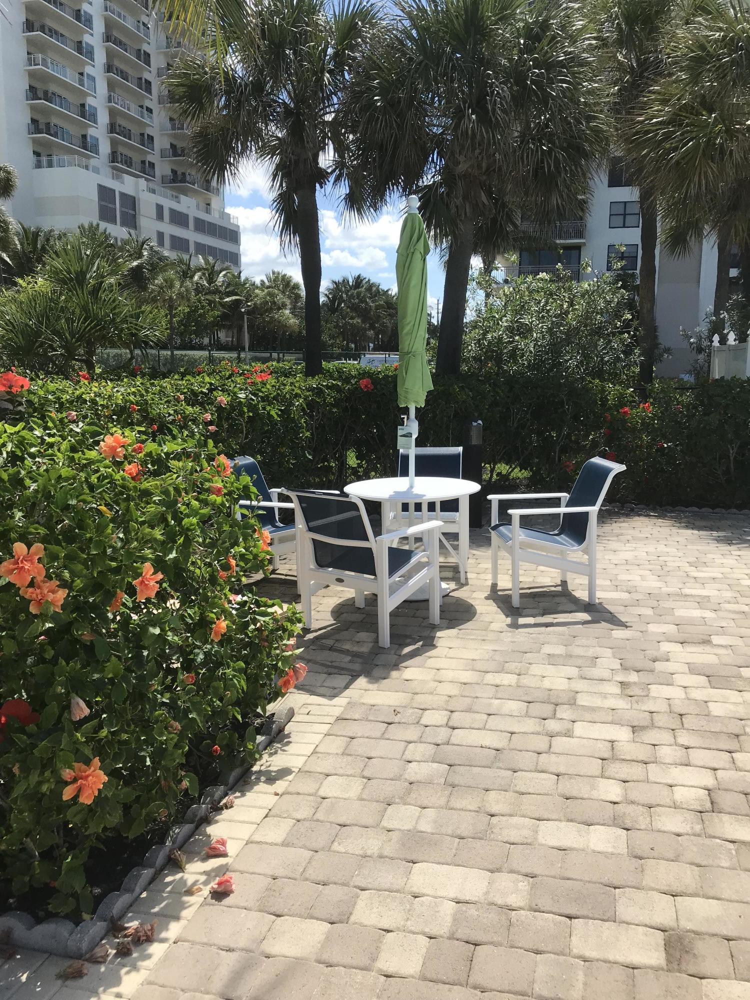 3400 North Ocean Drive, Unit 306 Riviera Beach, FL 33404 - Photo 34 of 52 a view of a chairs and tables in the patio