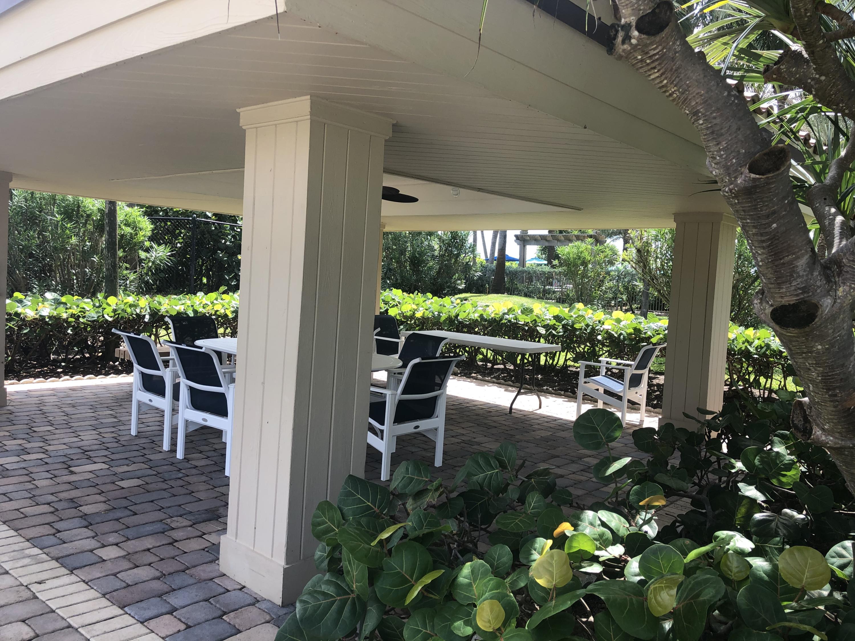 3400 North Ocean Drive, Unit 306 Riviera Beach, FL 33404 - Photo 38 of 52 a view of a porch with chairs and potted plants