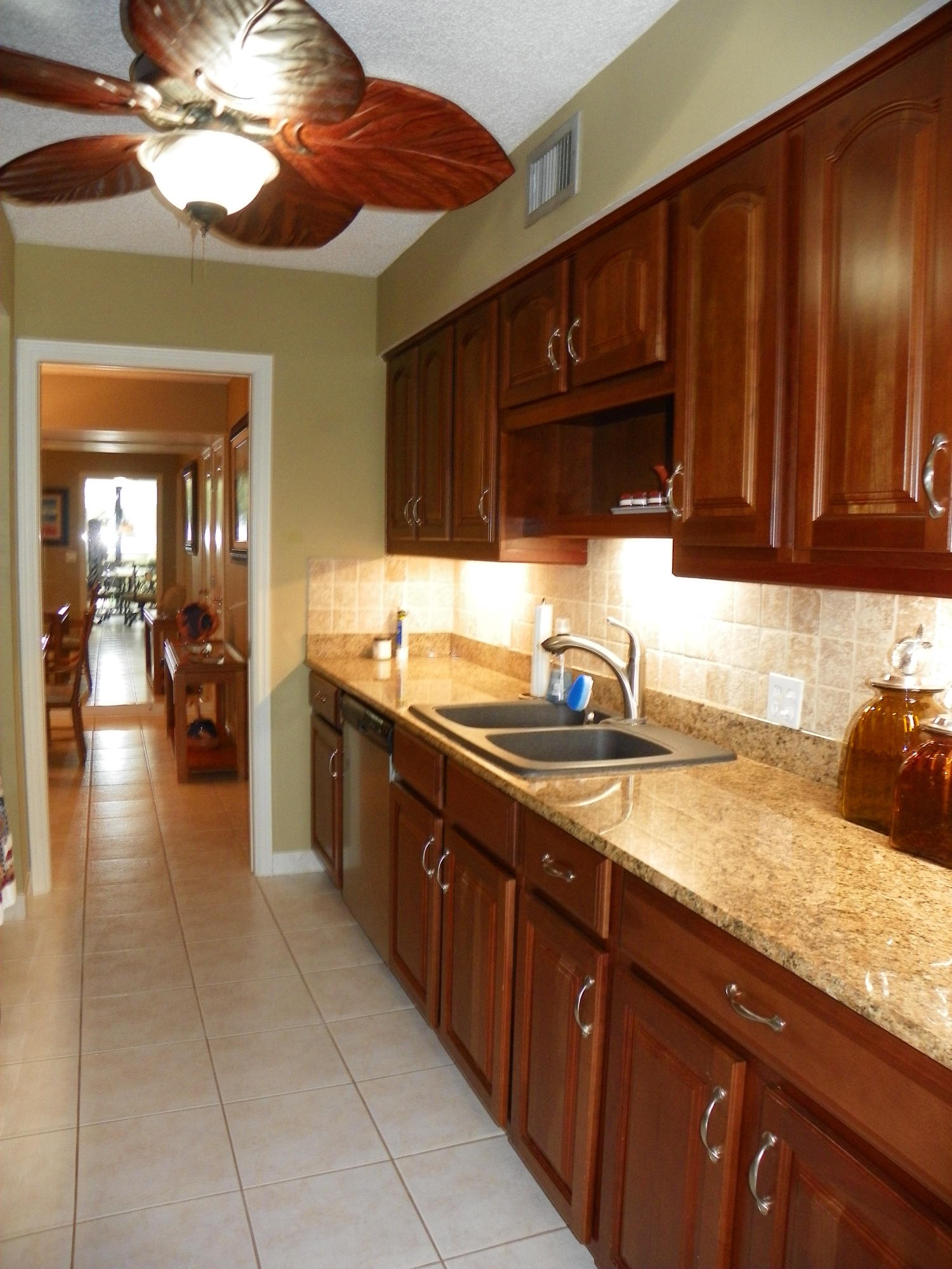 3400 North Ocean Drive, Unit 306 Riviera Beach, FL 33404 - Photo 4 of 52 a kitchen with a sink and cabinets