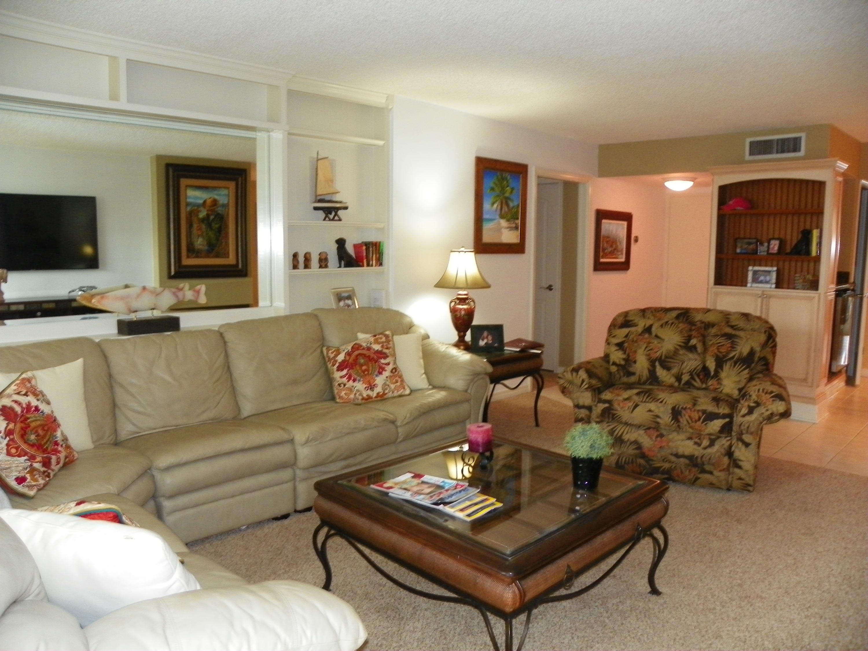 3400 North Ocean Drive, Unit 306 Riviera Beach, FL 33404 - Photo 8 of 52 a living room with furniture and a flat screen tv