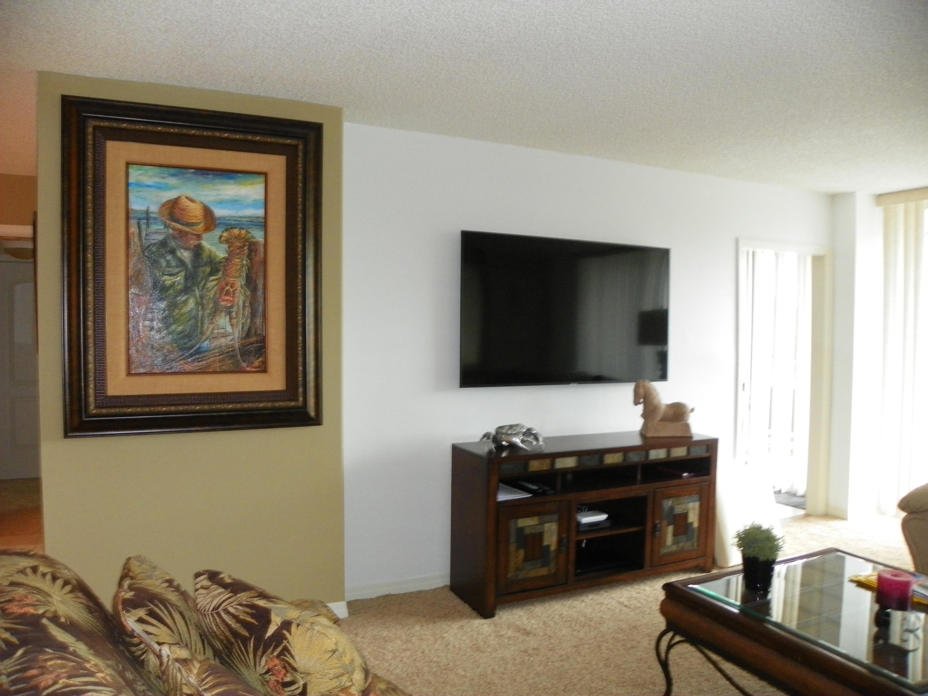 3400 North Ocean Drive, Unit 306 Riviera Beach, FL 33404 - Photo 9 of 52 a room with furniture and flat screen tv