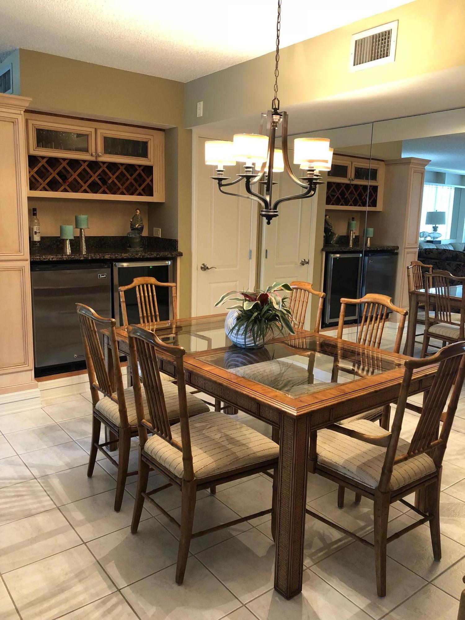 3400 North Ocean Drive, Unit 306 Riviera Beach, FL 33404 - Photo 10 of 52 a dining room with furniture and chandelier