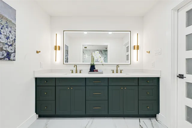 a bathroom with a double vanity sink and mirror
