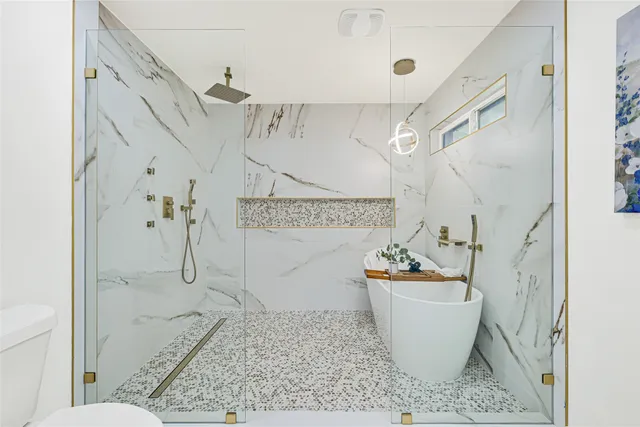 a bathroom with a bathtub and shower